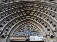 03B Looking up at the many small statues above the Porta Santa entrance to the Barcelona Cathedral Spain