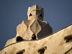 02A One of the rooftop chimneys from the street below La Pedrera Casa Mila Gaudi Barcelona Spain