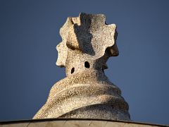 02B A rooftop chimney of stone with mosaics view from the street below La Pedrera Casa Mila Gaudi Barcelona Spain