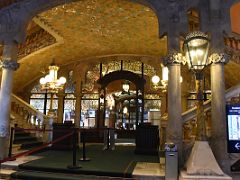 04A The entrance foyer has arches adorned with floral mosaics and stairs to the upper levels Palau de la Musica Catalana Barcelona Spain