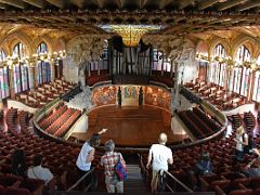 09A The concert auditorium from the upper level shows the seating areas, stage, ceiling, and skylight Palau de la Musica Catalana Barcelona Spain