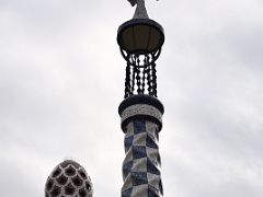 09B Porters Residence has a tower topped by a four-armed cross and a beautiful roof covered with trencadis, a mosaic made of tile shards Park Guell Barcelona Spain