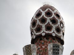 09C Porters Residence has what looks like a pine cone covered with trencadis, a mosaic made of tile shards Park Guell Barcelona Spain