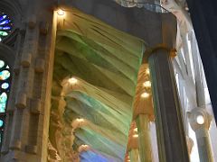 22D The stained glass windows on the east side illuminate the ceiling in greens and blues Sagrada Familia Barcelona Spain