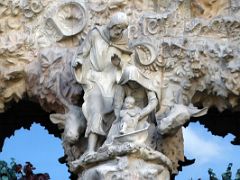 04F Baby Jesus is placed into a bassinet by Virgin Mary with Saint Joseph, ox and mule look on Charity portico Nativity facade Sagrada Familia Barcelona Spain