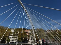 02A Zubizuri Calatrava Bridge consists of a curved walkway supported by steel suspension cables from an overhead arch Bilbao Spain