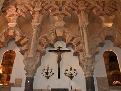 16A Statue of the crucifixion and Moorish arch inside the Villaviciosa Original Main Chapel Mezquita Mosque Cathedral Cordoba Spain