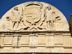 01C Relief of two warriors wearing Dalmatic and Spanish breeches, and holding the crest of the Spanish Crown Puerta del Puente Gate of the Bridge Roman Bridge Cordoba Spain