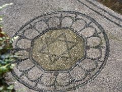 03C Large Stone Mosaic With Star Of David Close Up In Courtyard At Casa de Sefarad Sephardic Jewish museum Cordoba Spain